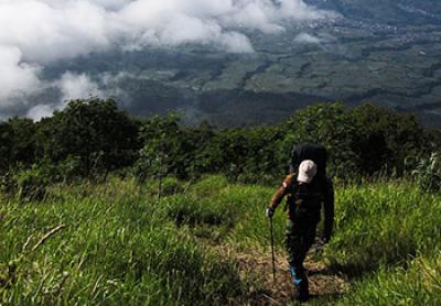 a man hiking in the hills of Indonesia